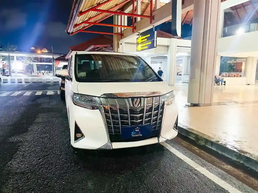 VIP airport transfer vehicle at terminal, evening